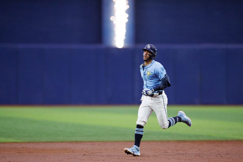 Jun 30, 2024; St. Petersburg, Florida, USA;  Tampa Bay Rays shortstop Jose Caballero (7) runs the bases after hitting a two-run home run against the Washington Nationals in the second inning at Tropicana Field. Mandatory Credit: Nathan Ray Seebeck-USA TODAY Sports