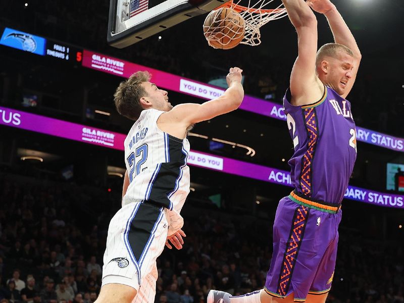 PHOENIX, ARIZONA - NOVEMBER 18: Mason Plumlee #22 of the Phoenix Suns reverse slam dunks the ball against Franz Wagner #22 of the Orlando Magic during the second half of the NBA game at Footprint Center on November 18, 2024 in Phoenix, Arizona.  NOTE TO USER: User expressly acknowledges and agrees that, by downloading and/or using this photograph, user is consenting to the terms and conditions of the Getty Images License Agreement. (Photo by Christian Petersen/Getty Images)