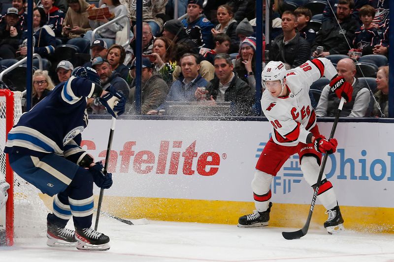 Feb 29, 2024; Columbus, Ohio, USA; Carolina Hurricanes center Martin Necas (88) looks to pass as Columbus Blue Jackets defenseman Ivan Provorov (9) defends during the second period at Nationwide Arena. Mandatory Credit: Russell LaBounty-USA TODAY Sports