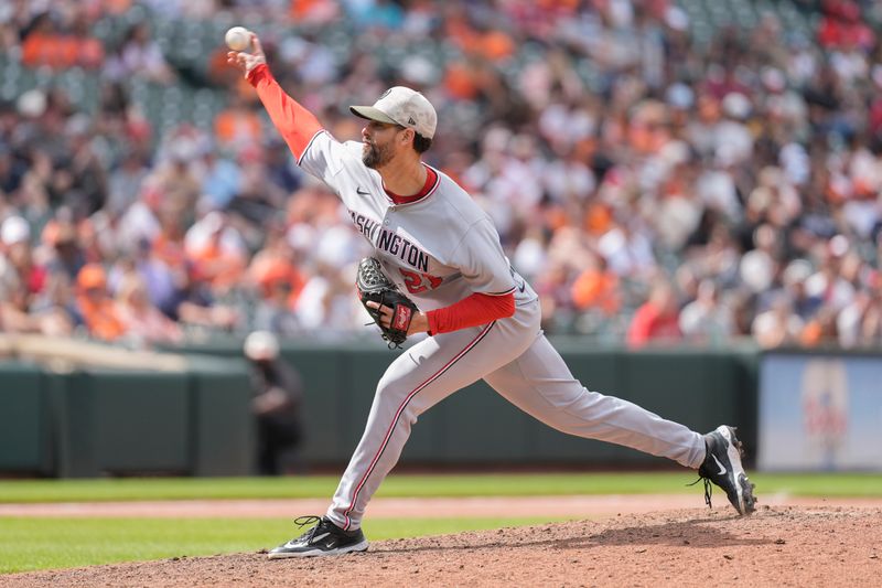 May 18, 2025; Baltimore, Maryland, USA; Washington Nationals pitcher Jorge Lopez (21) delivers a pitch against the Baltimore Orioles during the eighth inning at Oriole Park at Camden Yards. Mandatory Credit: Gregory Fisher-Imagn Images