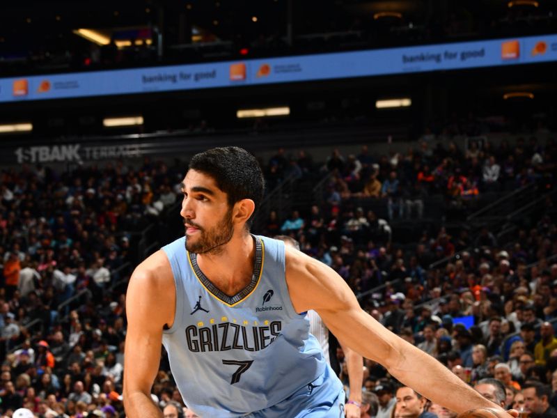 PHOENIX, AZ - FEBRUARY 11:  Santi Aldama #7 of the Memphis Grizzlies dribbles the ball during the game against the Phoenix Suns on February 11, 2025 at Footprint Center in Phoenix, Arizona. NOTE TO USER: User expressly acknowledges and agrees that, by downloading and or using this photograph, user is consenting to the terms and conditions of the Getty Images License Agreement. Mandatory Copyright Notice: Copyright 2025 NBAE (Photo by Barry Gossage/NBAE via Getty Images)