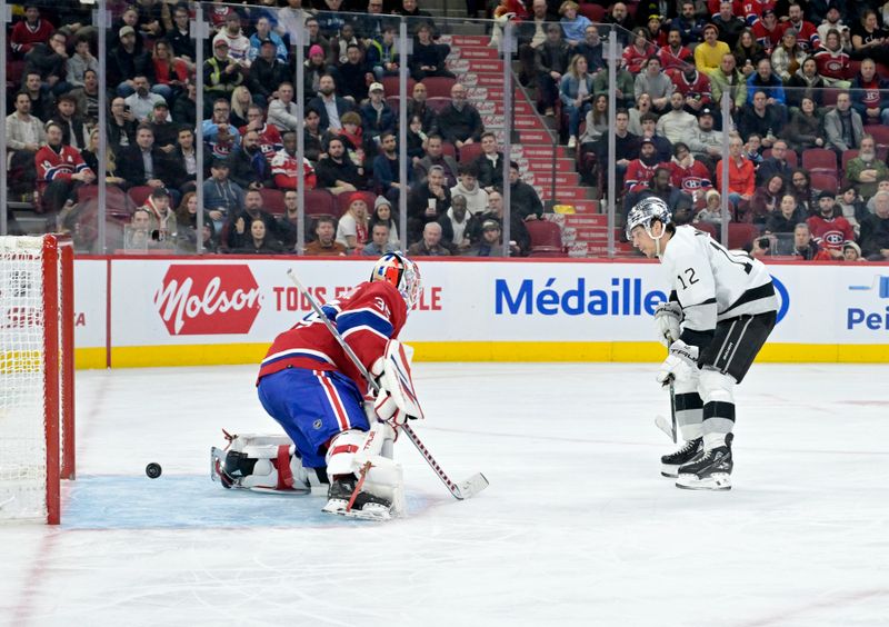 Dec 7, 2023; Montreal, Quebec, CAN; Los Angeles Kings forward Trevor Moore (12) scores a goal against Montreal Canadiens goalie Sam Montembeault (35) during the third period at the Bell Centre. Mandatory Credit: Eric Bolte-USA TODAY Sports