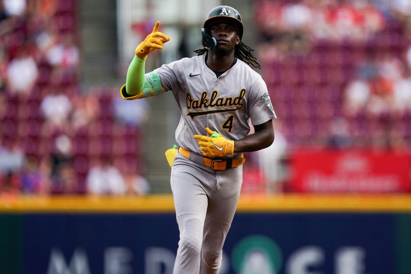 Aug 29, 2024; Cincinnati, Ohio, USA;  Oakland Athletics right fielder Lawrence Butler (4) gestures after scoring a home run during the fourth inning of the MLB game between the Cincinnati Reds and Oakland Athletics, Thursday, Aug. 29, 2024, at Cintas Center in Cincinnati. Mandatory Credit: Frank Bowen IV/The Cincinnati Enquirer-USA TODAY Sports