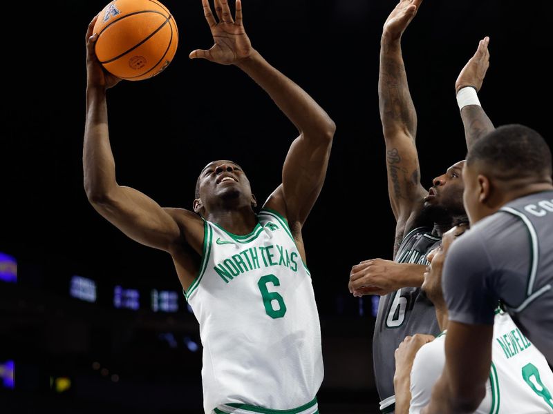 Mar 15, 2025; Fort Worth, TX, USA; North Texas Mean Green forward Brenen Lorient (6) shoots as UAB Blazers guard Tony Toney (6) defends during the first half at Dickies Arena. Mandatory Credit: Chris Jones-Imagn Images