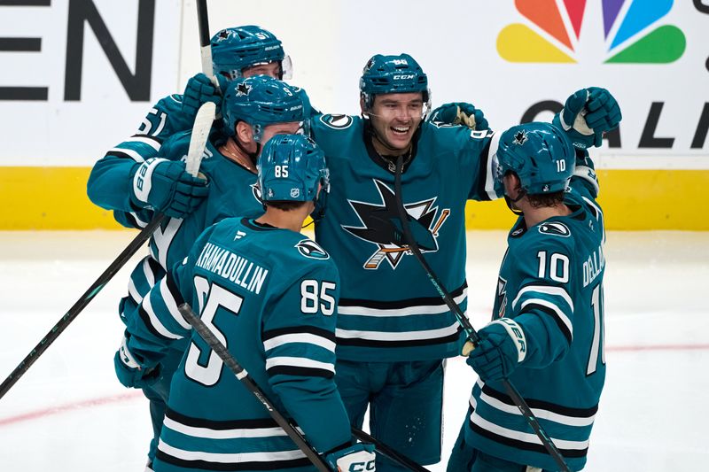 Oct 9, 2025; San Jose, California, USA; San Jose Sharks center Philipp Kurashev (96) celebrates with defenseman Shakir Mukhamadullin (85), center Ty Dellandrea (10) and his teammates after scoring a goal against the Vegas Golden Knights during the third period at SAP Center at San Jose. Mandatory Credit: Robert Edwards-Imagn Images