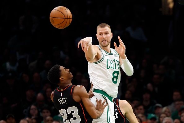 Boston, MA - December 28: Boston Celtics C Kristaps Porzingis passes the ball in the second quarter. The Celtics beat the Detroit Pistons, 128-122, in overtime. (Photo by Danielle Parhizkaran/The Boston Globe via Getty Images)