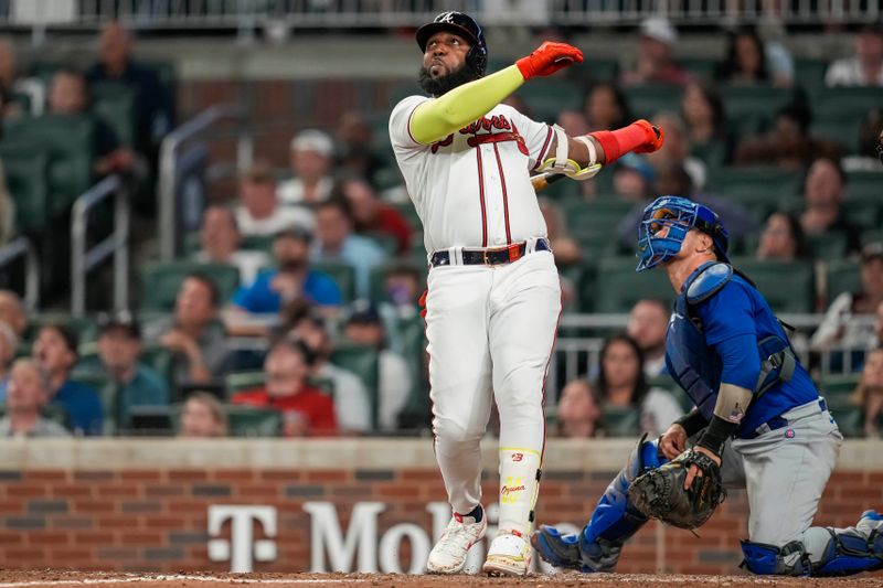 Sep 27, 2023; Cumberland, Georgia, USA; Atlanta Braves designated hitter Marcell Ozuna (20) hits a home run against the Chicago Cubs during the ninth inning at Truist Park. Mandatory Credit: Dale Zanine-USA TODAY Sports
