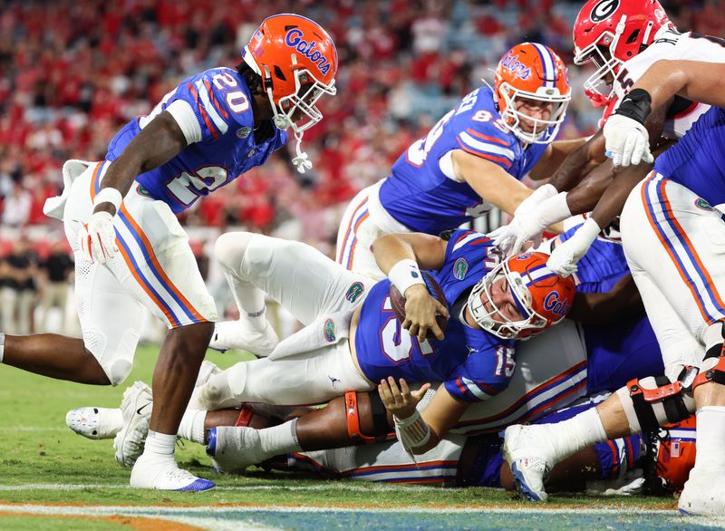 Oct 28, 2023; Jacksonville, Florida, USA; Florida Gators quarterback Graham Mertz (15) scores a touchdown against the Georgia Bulldogs during the second half at EverBank Stadium. Mandatory Credit: Kim Klement Neitzel-USA TODAY Sports