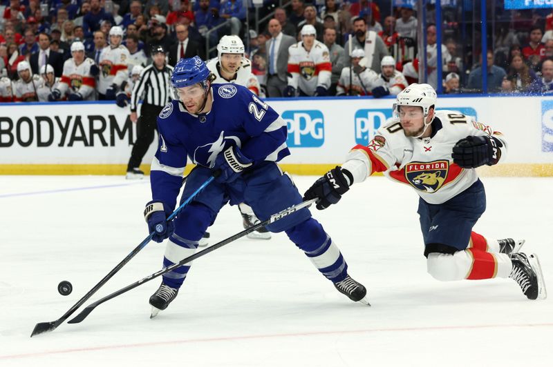 Apr 27, 2024; Tampa, Florida, USA; Florida Panthers right wing Vladimir Tarasenko (10) defends Tampa Bay Lightning center Brayden Point (21) during the first period in game four of the first round of the 2024 Stanley Cup Playoffs at Amalie Arena. Mandatory Credit: Kim Klement Neitzel-USA TODAY Sports