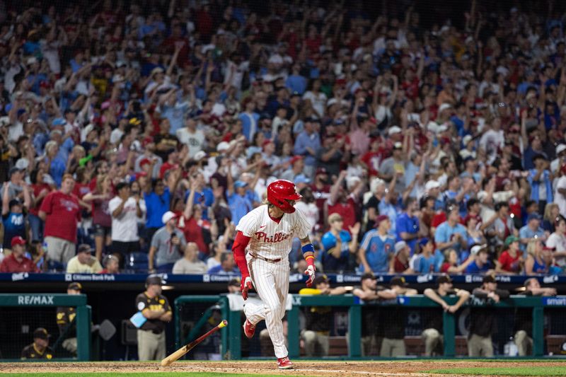 Jun 18, 2024; Philadelphia, Pennsylvania, USA; Philadelphia Phillies second base Bryson Stott (5) hits an RBI single during the ninth inning against the San Diego Padres at Citizens Bank Park. Mandatory Credit: Bill Streicher-USA TODAY Sports