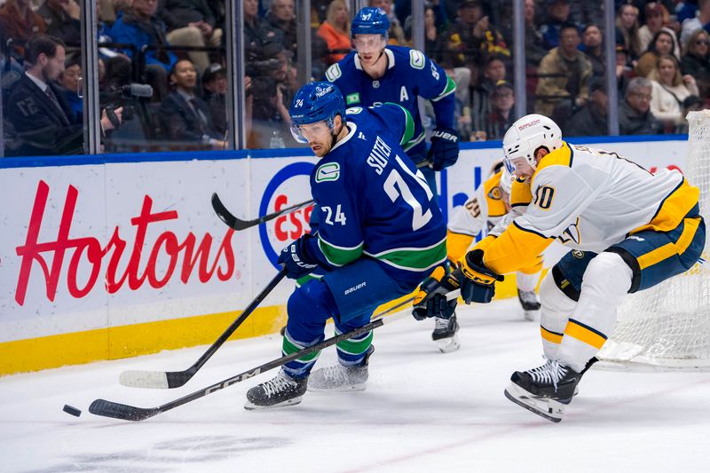 Jan 3, 2025; Vancouver, British Columbia, CAN; Nashville Predators forward Colton Sissons (10) stick checks Vancouver Canucks forward Pius Suter (24) in the first period at Rogers Arena. Mandatory Credit: Bob Frid-Imagn Images