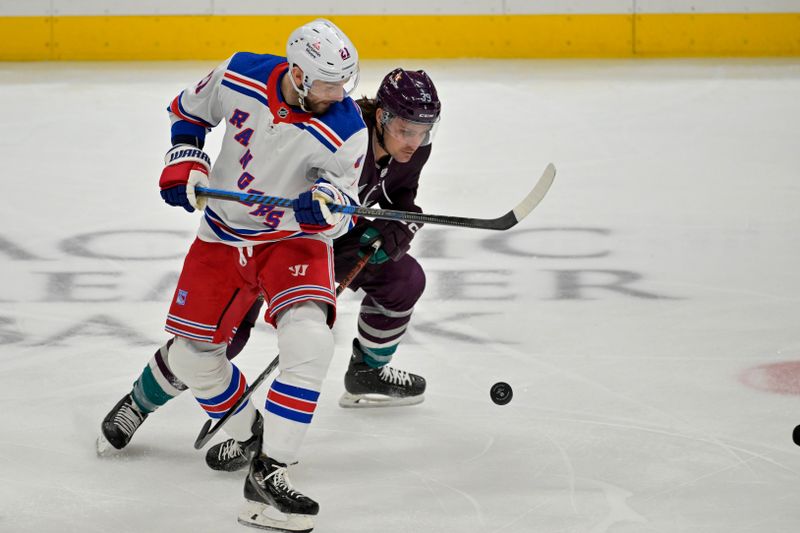 Jan 21, 2024; Anaheim, California, USA; New York Rangers center Barclay Goodrow (21) and Anaheim Ducks center Sam Carrick (39) battle for the puck in the first period at Honda Center. Mandatory Credit: Jayne Kamin-Oncea-USA TODAY Sports