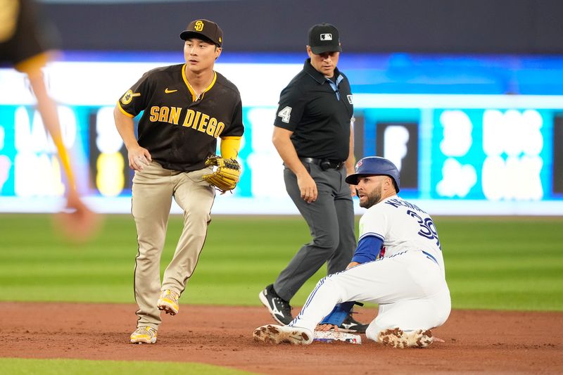 Jul 19, 2023; Toronto, Ontario, CAN; Toronto Blue Jays center fielder Kevin Kiermaier (39) steals second base as San Diego Padres second baseman Ha-Seong Kim (7) waits for the throw from the plate during the second inning at Rogers Centre. Mandatory Credit: John E. Sokolowski-USA TODAY Sports