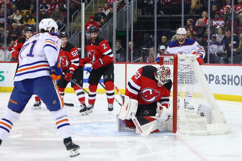 Dec 21, 2023; Newark, New Jersey, USA; Edmonton Oilers center Ryan McLeod (71) scores a goal on New Jersey Devils goaltender Akira Schmid (40) during the first period at Prudential Center. Mandatory Credit: Ed Mulholland-USA TODAY Sports