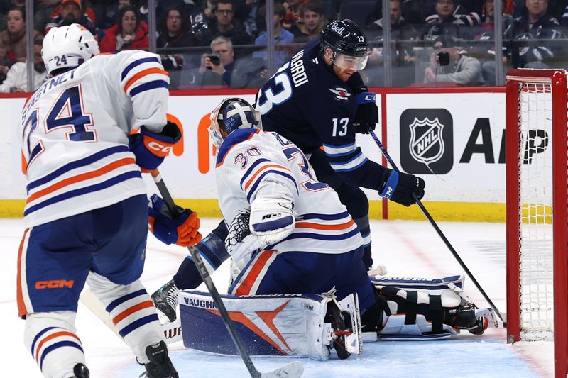 Jan 8, 2026; Winnipeg, Manitoba, CAN; Edmonton Oilers goaltender Calvin Pickard (30) blocks a shot by Winnipeg Jets center Gabriel Vilardi (13) in the second period at Canada Life Centre. Mandatory Credit: James Carey Lauder-Imagn Images