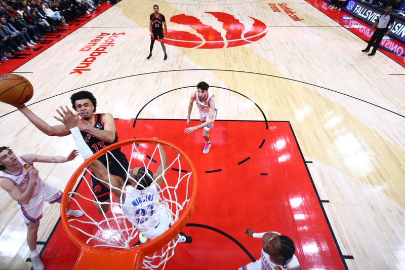 TORONTO, CANADA - MARCH 22:  Jordan Nwora #13 of the Toronto Raptors goes to the basket during the game on March 22, 2024 at the Scotiabank Arena in Toronto, Ontario, Canada.  NOTE TO USER: User expressly acknowledges and agrees that, by downloading and or using this Photograph, user is consenting to the terms and conditions of the Getty Images License Agreement.  Mandatory Copyright Notice: Copyright 2024 NBAE (Photo by Vaughn Ridley/NBAE via Getty Images)