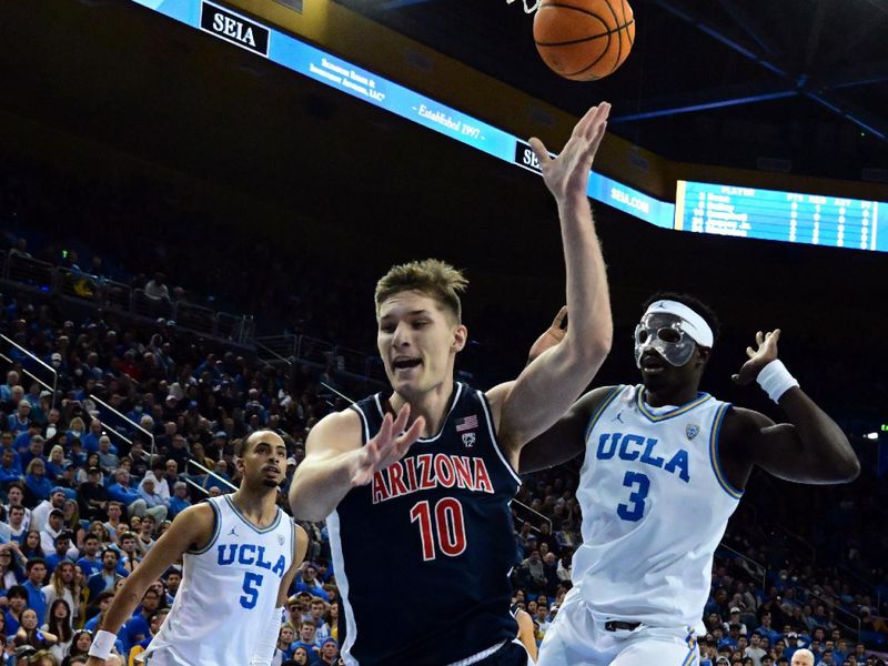 Mar 4, 2023; Los Angeles, California, USA;  Arizona Wildcats forward Azuolas Tubelis (10) drives to the basket and UCLA Bruins forward Adem Bona (3) defends during the first half at Pauley Pavilion presented by Wescom. Mandatory Credit: Richard Mackson-USA TODAY Sports