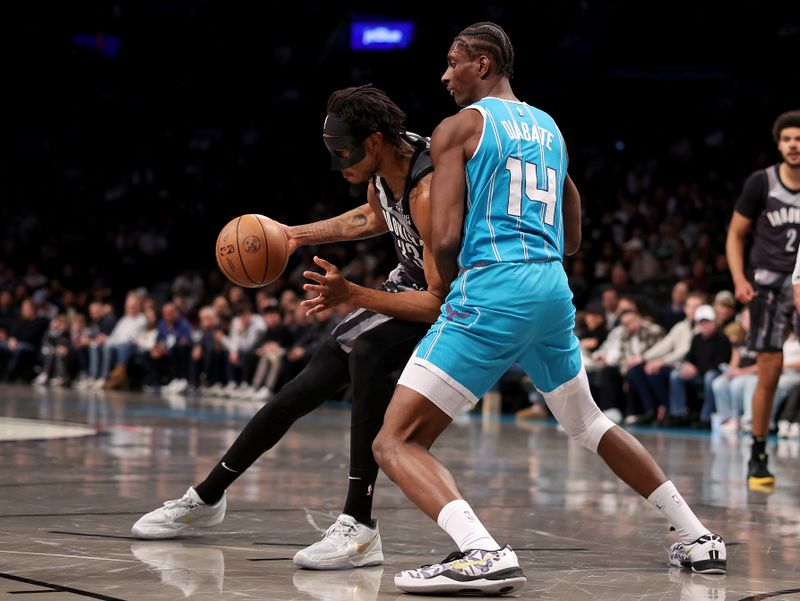 NEW YORK, NEW YORK - FEBRUARY 10: Nic Claxton #33 of the Brooklyn Nets heads for the net as Moussa Diabate #14 of the Charlotte Hornets defends in the first half at Barclays Center on February 10, 2025 in the Brooklyn borough of New York City. NOTE TO USER: User expressly acknowledges and agrees that, by downloading and or using this photograph, User is consenting to the terms and conditions of the Getty Images License Agreement. (Photo by Elsa/Getty Images)