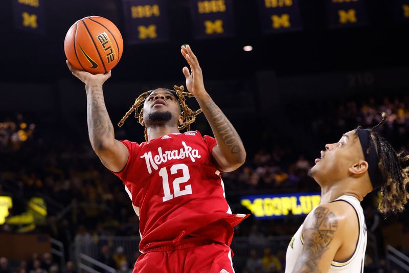 Feb 8, 2023; Ann Arbor, Michigan, USA;  Nebraska Cornhuskers guard Denim Dawson (12) shoots on Michigan Wolverines forward Terrance Williams II (5) in the second half at Crisler Center. Mandatory Credit: Rick Osentoski-USA TODAY Sports