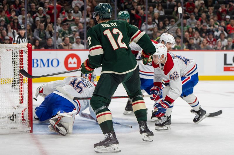 Nov 14, 2024; Saint Paul, Minnesota, USA; Minnesota Wild left wing Matt Boldy (12) scores on Montreal Canadiens goaltender Sam Montembeault (35) in the second period at Xcel Energy Center. Mandatory Credit: Matt Blewett-Imagn Images