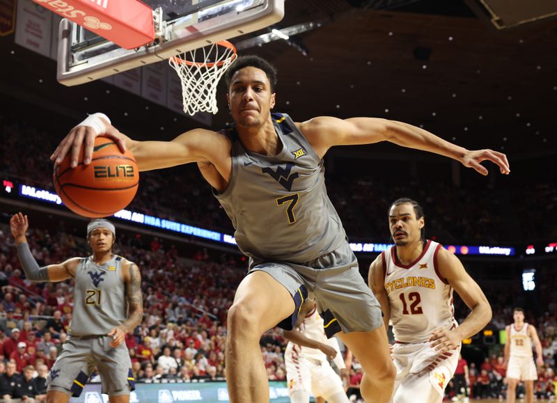 Feb 24, 2024; Ames, Iowa, USA; West Virginia Mountaineers center Jesse Edwards (7) saves a ball from going out of bounds against the Iowa State Cyclones during the first half at James H. Hilton Coliseum. Mandatory Credit: Reese Strickland-USA TODAY Sports