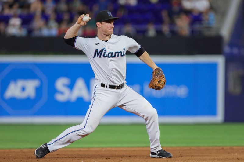 Jul 30, 2023; Miami, Florida, USA; Miami Marlins shortstop Joey Wendle (18) throws to first baseman Yuli Gurriel (not pictured) and retires Detroit Tigers shortstop Javier Baez (not pictured) during the ninth inning at loanDepot Park. Mandatory Credit: Sam Navarro-USA TODAY Sports