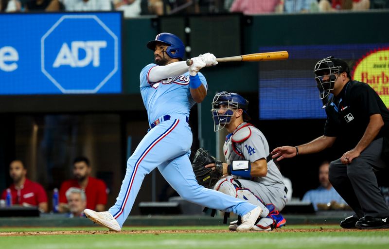 Jul 23, 2023; Arlington, Texas, USA;  Texas Rangers shortstop Ezequiel Duran (20) hits an rbi double during the fourth inning against the Los Angeles Dodgers at Globe Life Field. Mandatory Credit: Kevin Jairaj-USA TODAY Sports