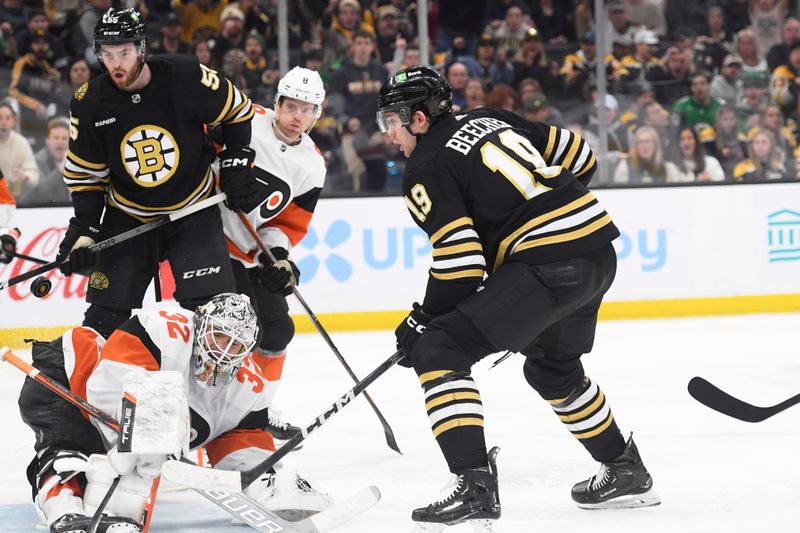 Mar 16, 2024; Boston, Massachusetts, USA; Boston Bruins center Johnny Beecher (19) tips the puck past Philadelphia Flyers goaltender Felix Sandstrom (32) during the third period at TD Garden. Mandatory Credit: Bob DeChiara-USA TODAY Sports