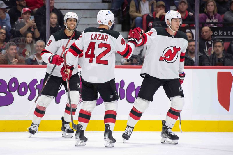 Oct 17, 2024; Ottawa, Ontario, CAN; New Jersey Devils right wing Nathan Bastian (14) skates to the bench after scoring a goal in the second period against the Ottawa Senators at the Canadian Tire Centre. Mandatory Credit: Marc DesRosiers-Imagn Images