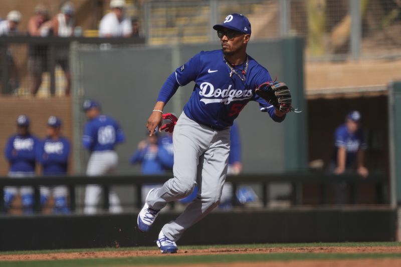 Feb 27, 2025; Salt River Pima-Maricopa, Arizona, USA; Los Angeles Dodgers shortstop Mookie Betts (50) reacts to a play against the Colorado Rockies during the first inning at Salt River Fields at Talking Stick. Mandatory Credit: Rick Scuteri-Imagn Images