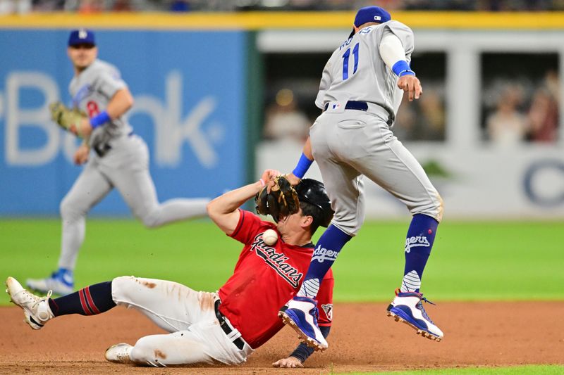 Aug 22, 2023; Cleveland, Ohio, USA; Cleveland Guardians right fielder Will Brennan (17) steals second as Los Angeles Dodgers shortstop Miguel Rojas (11) loses the ball on the tag during the seventh inning at Progressive Field. Mandatory Credit: Ken Blaze-USA TODAY Sports