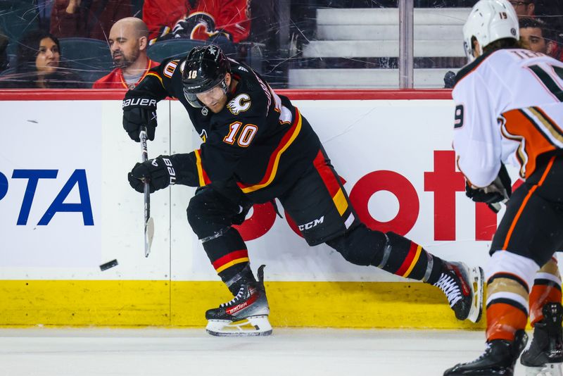 Apr 2, 2024; Calgary, Alberta, CAN; Calgary Flames center Jonathan Huberdeau (10) controls the puck against the Anaheim Ducks during the second period at Scotiabank Saddledome. Mandatory Credit: Sergei Belski-USA TODAY Sports