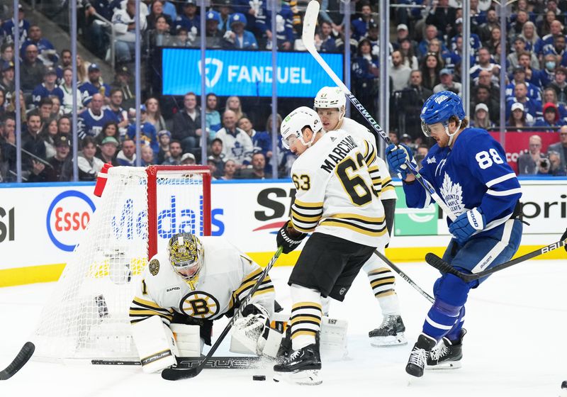 Apr 27, 2024; Toronto, Ontario, CAN; Toronto Maple Leafs right wing William Nylander (88) battles for the puck with Boston Bruins left wing Brad Marchand (63) in front of  goaltender Jeremy Swayman (1) during the first period in game four of the first round of the 2024 Stanley Cup Playoffs at Scotiabank Arena. Mandatory Credit: Nick Turchiaro-USA TODAY Sports