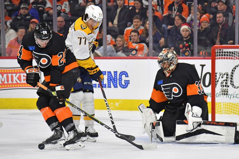 Dec 21, 2023; Philadelphia, Pennsylvania, USA; Philadelphia Flyers defenseman Nick Seeler (24) blocks a shot in front of Nashville Predators right wing Luke Evangelista (77) and goaltender Samuel Ersson (33) during the first period at Wells Fargo Center. Mandatory Credit: Eric Hartline-USA TODAY Sports