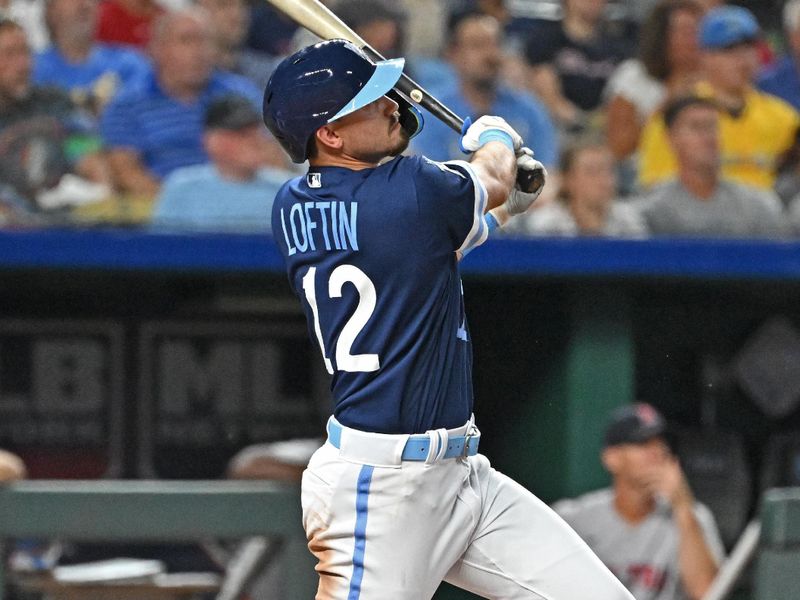 Sep 1, 2023; Kansas City, Missouri, USA;  Kansas City Royals designated hitter Nick Loftin (12) hits an RBI double for his first Major League hit in the third inning against the Boston Red Sox at Kauffman Stadium. Mandatory Credit: Peter Aiken-USA TODAY Sports