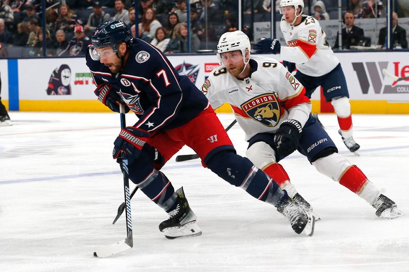 Oct 15, 2024; Columbus, Ohio, USA; Columbus Blue Jackets center Sean Kuraly (7) controls the puck as Florida Panthers center Sam Bennett (9) defends during the first period at Nationwide Arena. Mandatory Credit: Russell LaBounty-Imagn Images