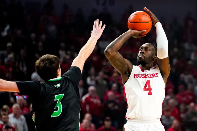 Dec 20, 2023; Lincoln, Nebraska, USA; Nebraska Cornhuskers forward Juwan Gary (4) shoots the ball against North Dakota Fighting Hawks forward Amar Kuljuhovic (3) during the first half at Pinnacle Bank Arena. Mandatory Credit: Dylan Widger-USA TODAY Sports