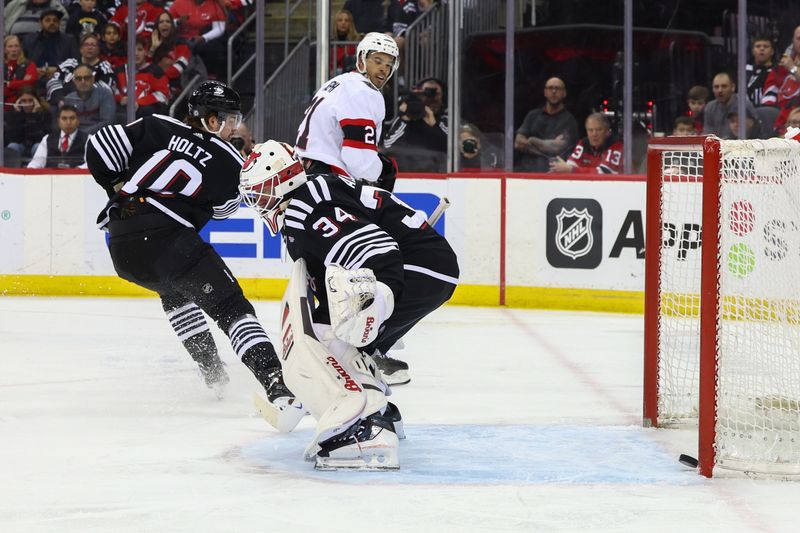 Mar 23, 2024; Newark, New Jersey, USA; Ottawa Senators right wing Mathieu Joseph (21) scores a goal on New Jersey Devils goaltender Jake Allen (34) during the first period at Prudential Center. Mandatory Credit: Ed Mulholland-USA TODAY Sports