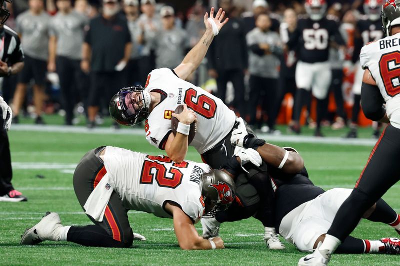 Tampa Bay Buccaneers quarterback Baker Mayfield (6) reacts as he is sacked by Atlanta Falcons defensive tackle David Onyemata (90) during the second half of an NFL football game Thursday, Oct. 3, 2024, in Atlanta. (AP Photo/Butch Dill)