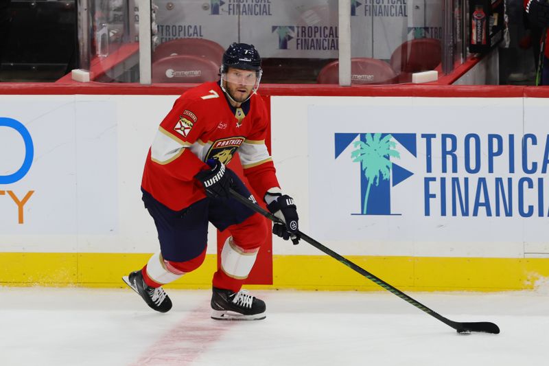 Oct 8, 2024; Sunrise, Florida, USA; Florida Panthers defenseman Dmitry Kulikov (7) moves the puck against the Boston Bruins during the third period at Amerant Bank Arena. Mandatory Credit: Sam Navarro-Imagn Images