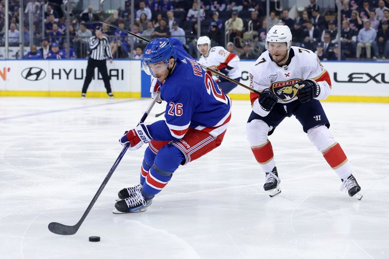 May 22, 2024; New York, New York, USA; 
29plays the puck against Florida Panthers defenseman Dmitry Kulikov (7) during the third period of game one of the Eastern Conference Final of the 2024 Stanley Cup Playoffs at Madison Square Garden. Mandatory Credit: Brad Penner-USA TODAY Sports