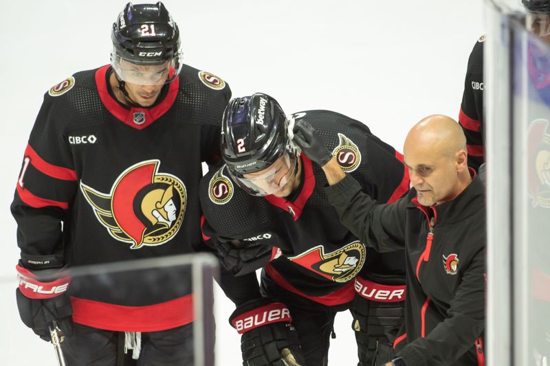 Oct 18, 2023; Ottawa, Ontario, CAN; Ottawa Senators defenseman Artem Zub (2) takes a shot to the head in the third period against the Washington Capitals at the Canadian Tire Centre. Mandatory Credit: Marc DesRosiers-USA TODAY Sports