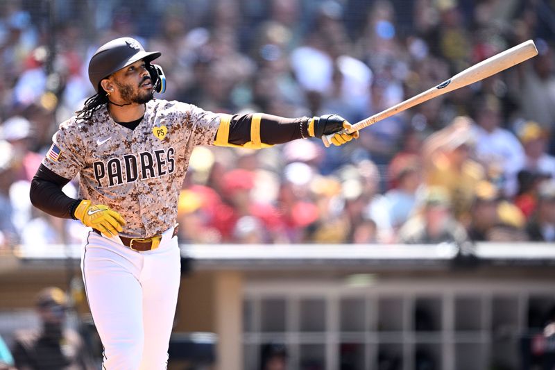 Jul 14, 2024; San Diego, California, USA; San Diego Padres pinch-hitter Luis Campusano (12) hits a two-run home run against the Atlanta Braves during the seventh inning at Petco Park. Mandatory Credit: Orlando Ramirez-USA TODAY Sports