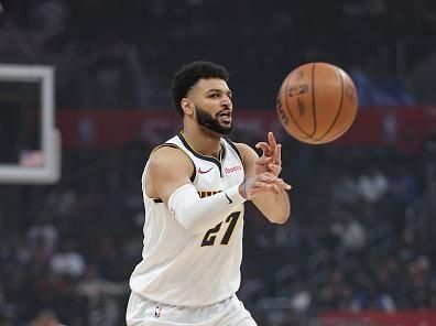 LOS ANGELES, CALIFORNIA - DECEMBER 06: Jamal Murray #27 of the Denver Nuggets passes against the LA Clippers during the first half of a game at Crypto.com Arena on December 06, 2023 in Los Angeles, California. NOTE TO USER: User expressly acknowledges and agrees that, by downloading and or using this photograph, User is consenting to the terms and conditions of the Getty Images License Agreement. (Photo by Michael Owens/Getty Images)