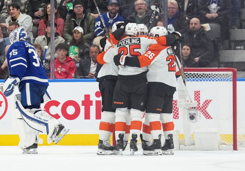 Feb 15, 2024; Toronto, Ontario, CAN; Philadelphia Flyers center Ryan Poehling (25) and defenseman Sean Walker (26) celebrate a goal by right wing Garnet Hathaway (19) (not pictured)  against the Toronto Maple Leafs during the third period at Scotiabank Arena. Mandatory Credit: Nick Turchiaro-USA TODAY Sports