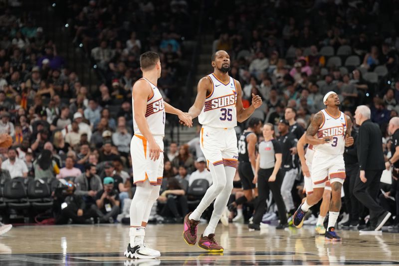 SAN ANTONIO, TX - MARCH 23:  Grayson Allen #8 high fives  Kevin Durant #35 of the Phoenix Suns during the game against the San Antonio Spurs on March 23, 2024 at the Frost Bank Center in San Antonio, Texas. NOTE TO USER: User expressly acknowledges and agrees that, by downloading and or using this photograph, user is consenting to the terms and conditions of the Getty Images License Agreement. Mandatory Copyright Notice: Copyright 2024 NBAE (Photos by Jesse D. Garrabrant/NBAE via Getty Images)