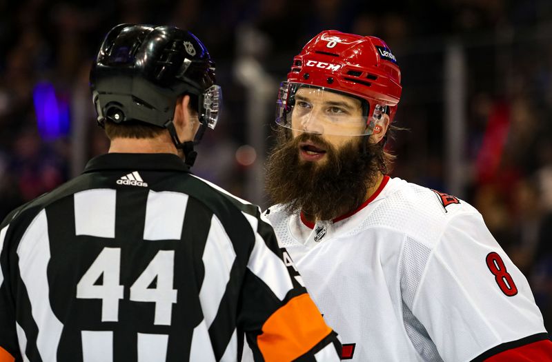 Jan 2, 2024; New York, New York, USA; Carolina Hurricanes defenseman Brent Burns (8) speaks with referee Justin Kea (44) during the first period against the New York Rangers at Madison Square Garden. Mandatory Credit: Danny Wild-USA TODAY Sports