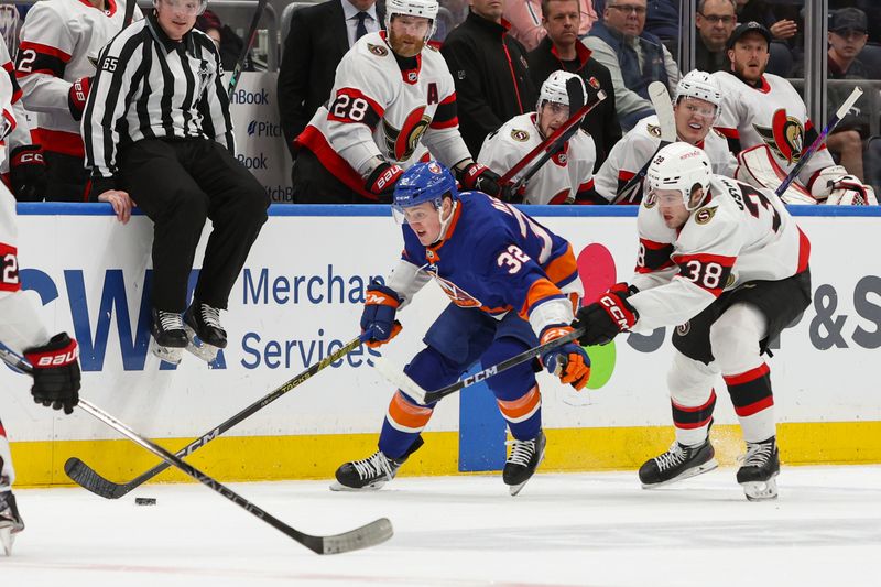 Mar 16, 2024; Elmont, New York, USA;  New York Islanders center Kyle MacLean (32) and Ottawa Senators center Zack Ostapchuk (38) go for the puck during the second period at UBS Arena. Mandatory Credit: Thomas Salus-USA TODAY Sports