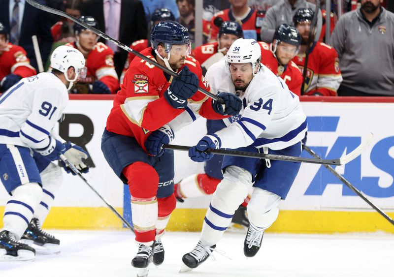 May 11, 2025; Sunrise, Florida, USA; Florida Panthers center Sam Reinhart (13) and Toronto Maple Leafs center Auston Matthews (34) skate during the second period in game four of the second round of the 2025 Stanley Cup Playoffs at Amerant Bank Arena. Mandatory Credit: Kim Klement Neitzel-Imagn Images