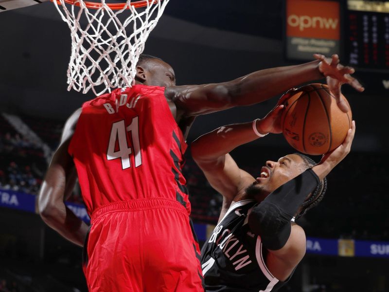 PORTLAND, OR - JANUARY 17: Ibou Badji #41 of the Portland Trail Blazers blocks the ball during the game against Dennis Smith Jr. #4 of the Brooklyn Nets on January 17, 2024 at the Moda Center Arena in Portland, Oregon. NOTE TO USER: User expressly acknowledges and agrees that, by downloading and or using this photograph, user is consenting to the terms and conditions of the Getty Images License Agreement. Mandatory Copyright Notice: Copyright 2024 NBAE (Photo by Cameron Browne/NBAE via Getty Images)